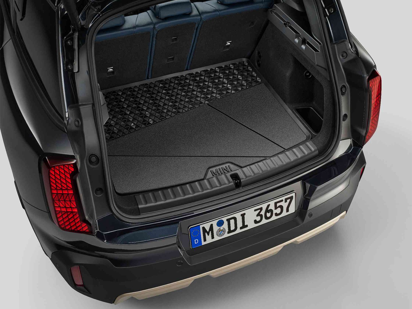 Black, custom-fit MINI boot compartment mat with high all-round edge to protect against dirt and moisture.